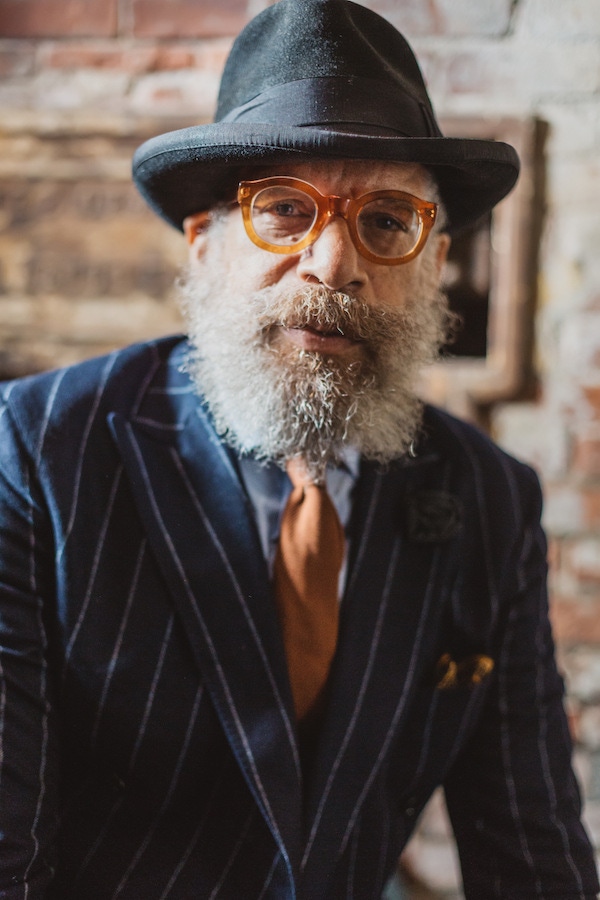 Ignacio's unconventional spectacles are vintage, from 1940s France. The thick acetate frames complement the warm tones of his tie and pocket square.