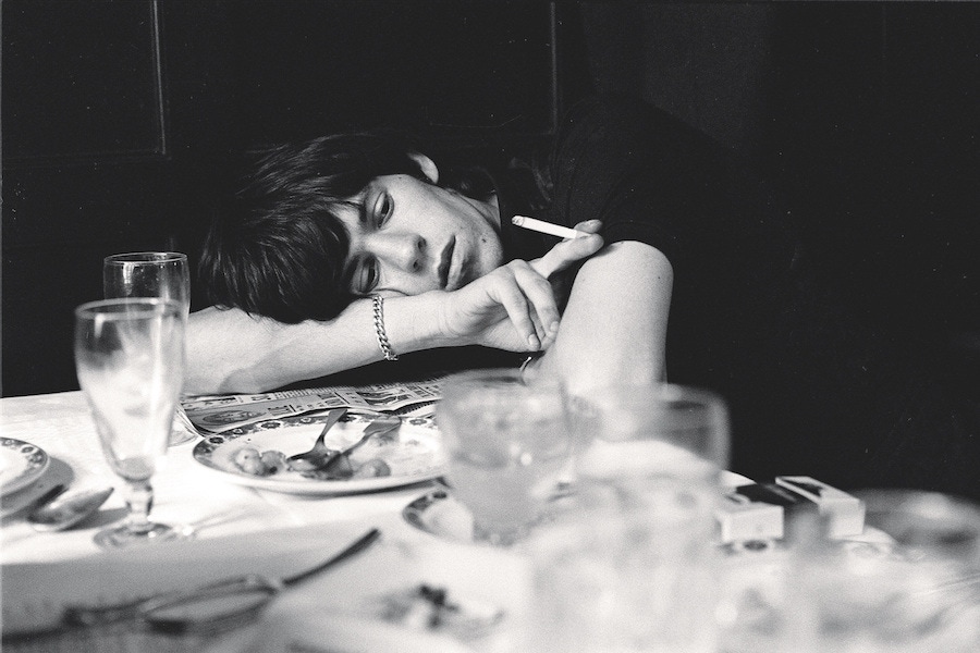 Dining out aged 21 wearing a casual T-shirt and silver chain bracelet, 1964. Photograph by TERRY O'NEILL/REX/Shutterstock.