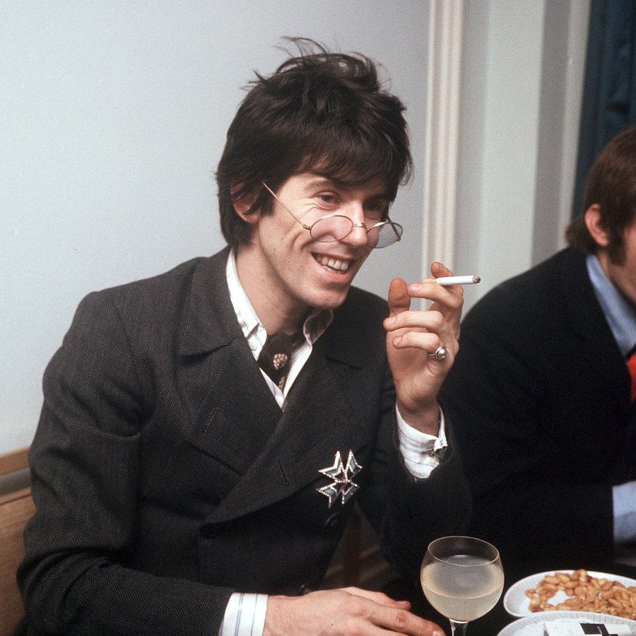 Wearing a double-breasted jacket, striped button-down shirt, neckerchief and rounded shades in 1967. Photograph by DEZO HOFFMANN/REX/Shutterstock.