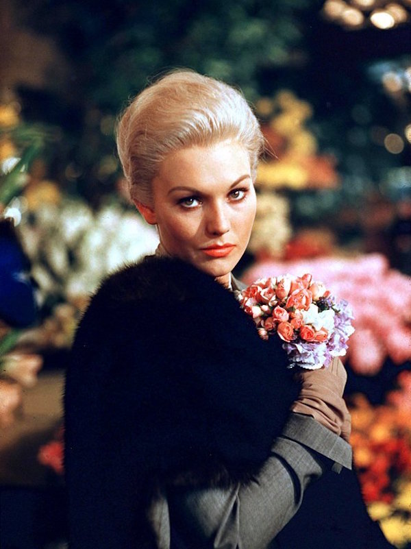 The striking actress dressed in a lavish fur stole on set for Vertigo, 1958.