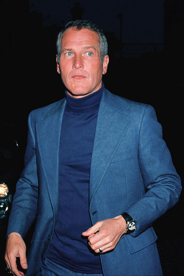 Paul Newman’s take on tonal dressing is a single-breasted blue suit with notched lapels paired with a navy roll neck jumper, accessorised with his Rolex Daytona.