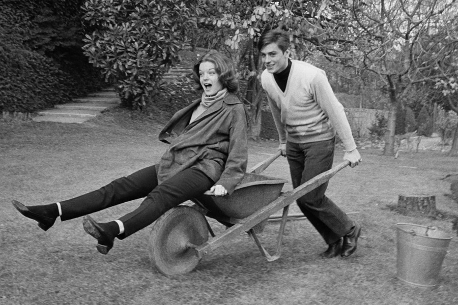 Alain Delon styles his V-neck with a black turtle neck.