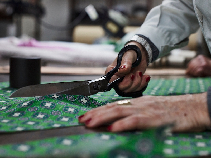A craftswoman carefully cuts Francesco Marino's printed silk cloth. Photograph by James Munro.