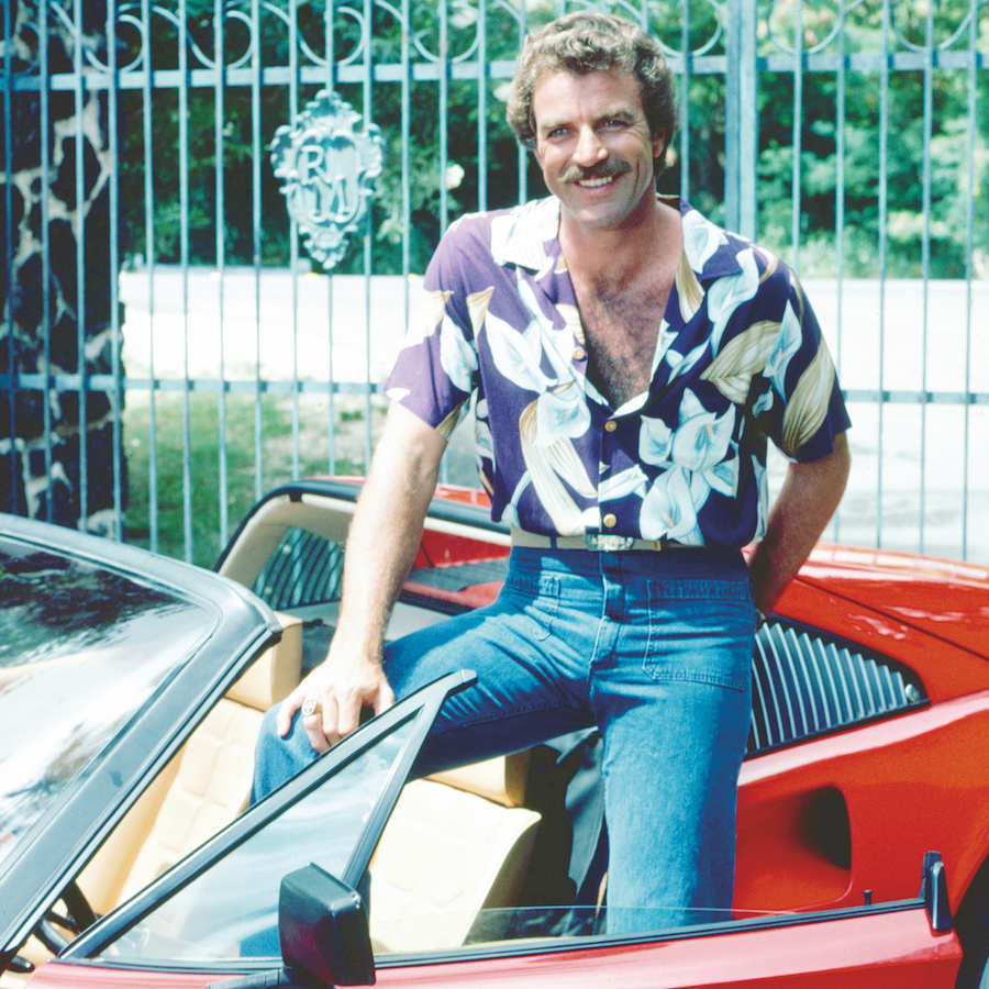 Tom Selleck as the titular investigator in the television series 'Magnum, P.I.', loved two things – his red Ferrari 308 and Hawaiian shirts. Pictured here on set, circa 1985. Photograph by Silver Screen Collection/Archive Photos/Getty Images.