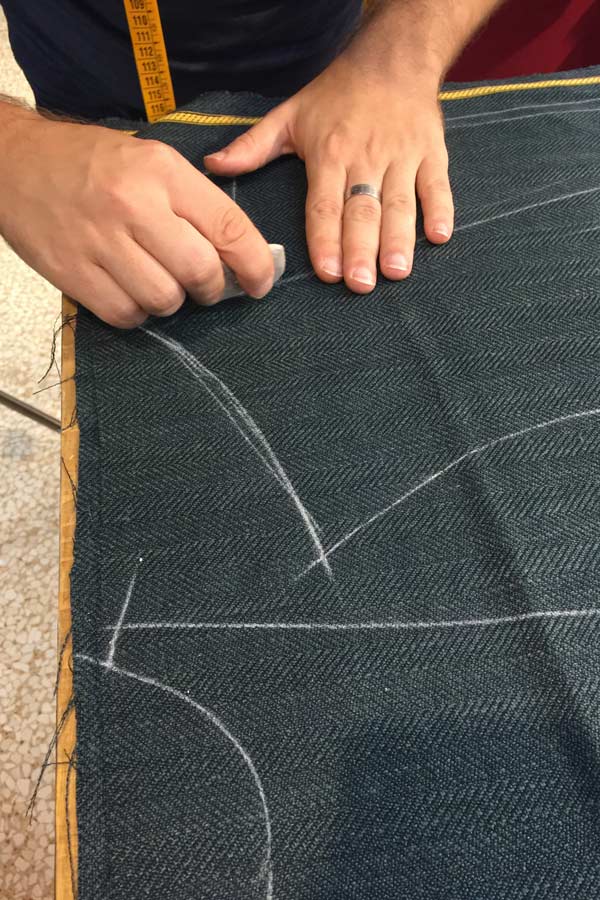 A jacket being marked out with tailor's chalk.