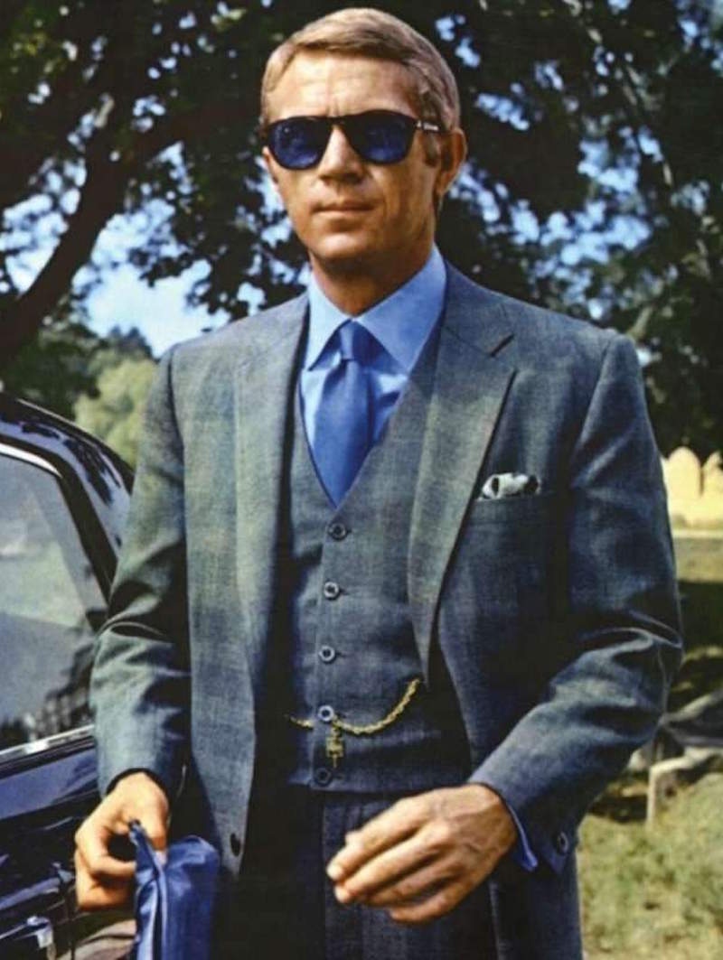 Throughout The Thomas Crown Affair, 1968, McQueen is exceptionally well dressed. This grey Prince of Wales check with hints of blue was created by the famed Savile Row tailor, Douglas Hayward.