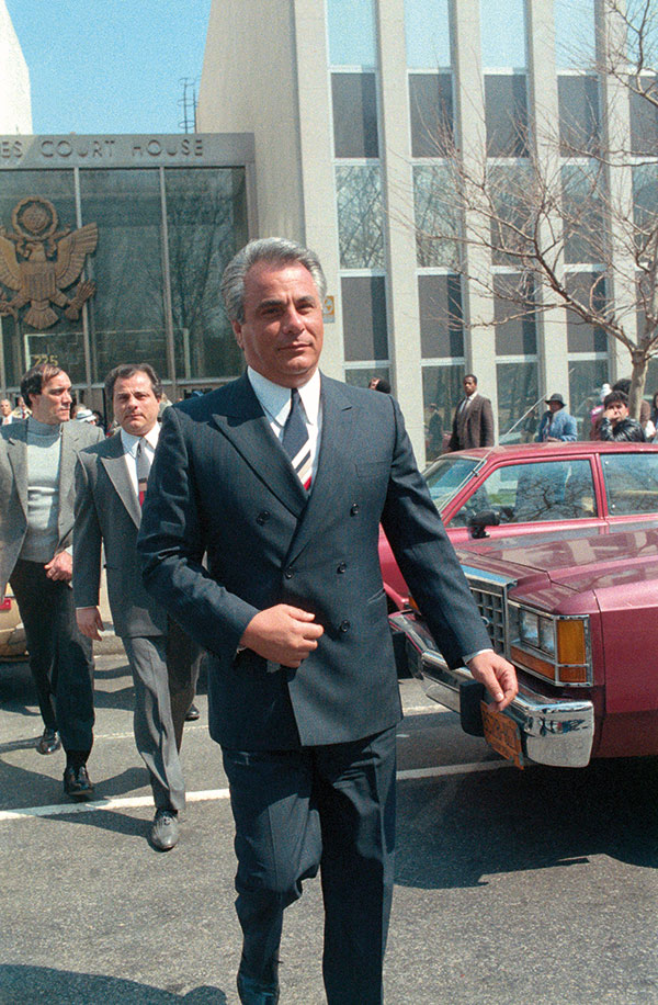 The 'Teflon Don' walks away from the Brooklyn Federal Court where he was on trial for racketeering (Getty).