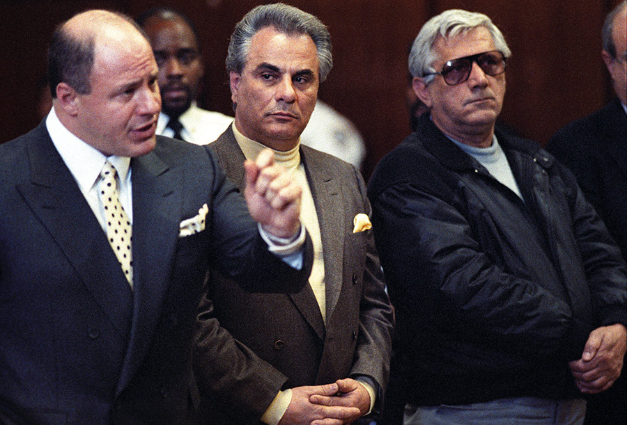 Gotti pictured matching a pale lemon rollneck sweater with his pocket square in a single-breasted suit (Getty).