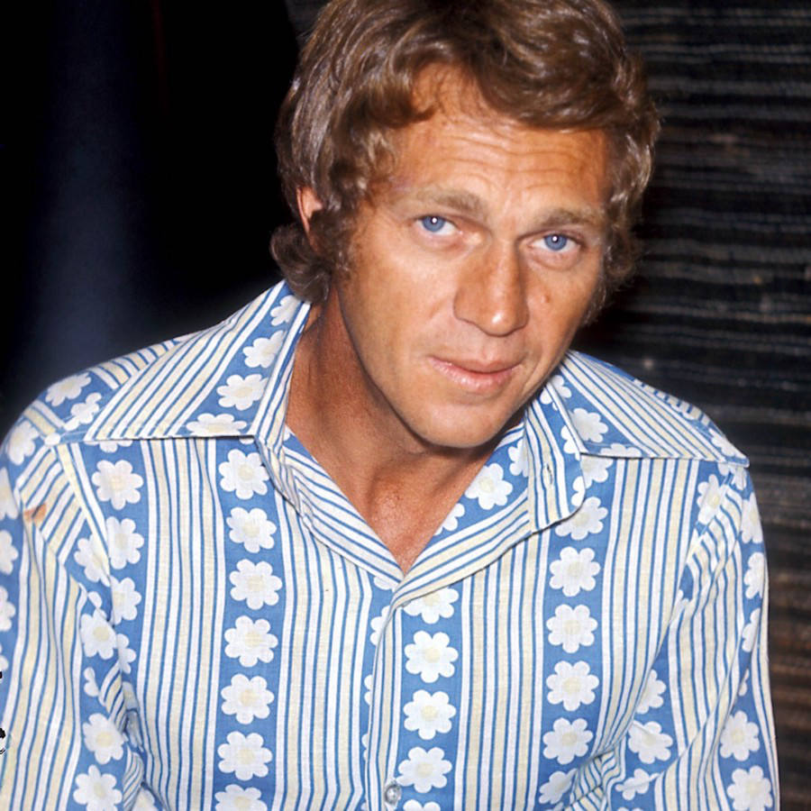 Steve McQueen’s blue floral shirt has an emphasised collar and tones of yellow running throughout, 1969.