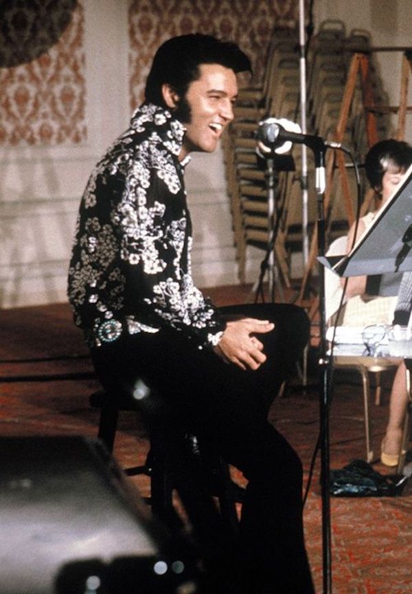 Elvis Presley sports a black shirt with a white floral motif along with his signature quiff and side-burns while rehearsing at the International Hotel Las Vegas, 1970.