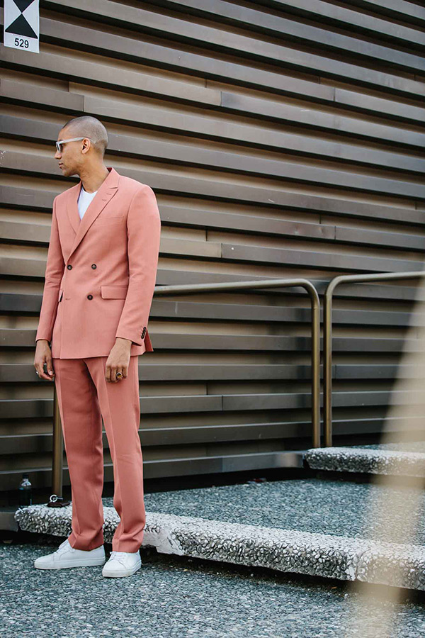 Downplay the flamboyance of a pastel pink suit with a pair of fresh white sneakers and matching t-shirt.