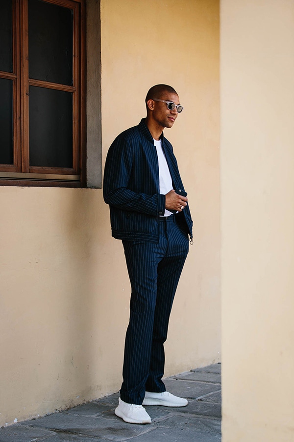 Pinstripes can be consummately casual when matched up with a minimal pair of white sneakers.