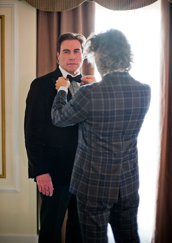 Designer Matteo Perin puts the final touches to John Travolta's black tie ensemble (Thorsten Overgaard).