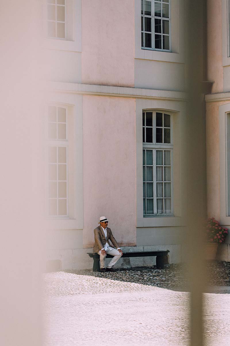 A well-dressed gentleman relaxes at the picturesque setting for the Concours d'Elégance Suisse.