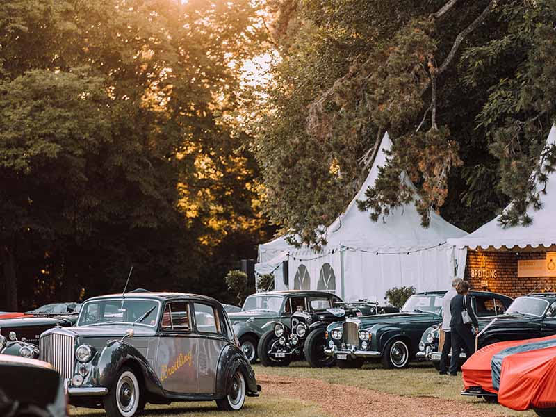 Rows of classic cars waiting to be judged as the sun sets on Geneva.