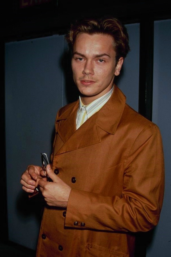 Phoenix wears a tan-coloured jacket, 1991.