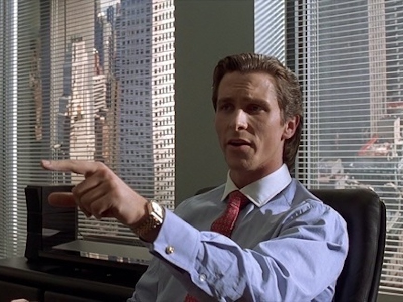 Christian Bale as Patick Bateman in the seminal movie American Psycho (2000) wears a neat set of gold cufflinks with his constrast collar shirt.