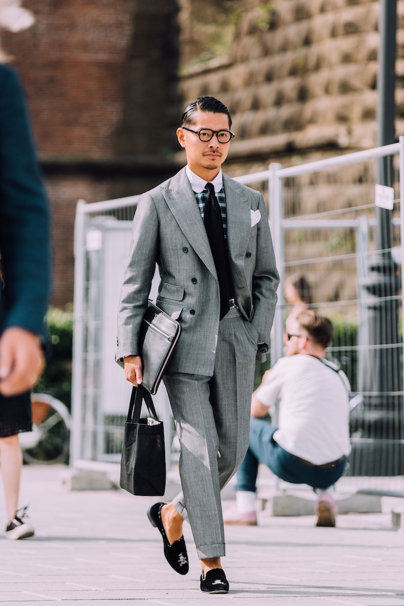 Tomoyoshi Takada perfectly demonstrating how to boss a double-breasted grey suit with a cropped turn-up trouser. Note the addition of velvet slippers to rip up the rule book.