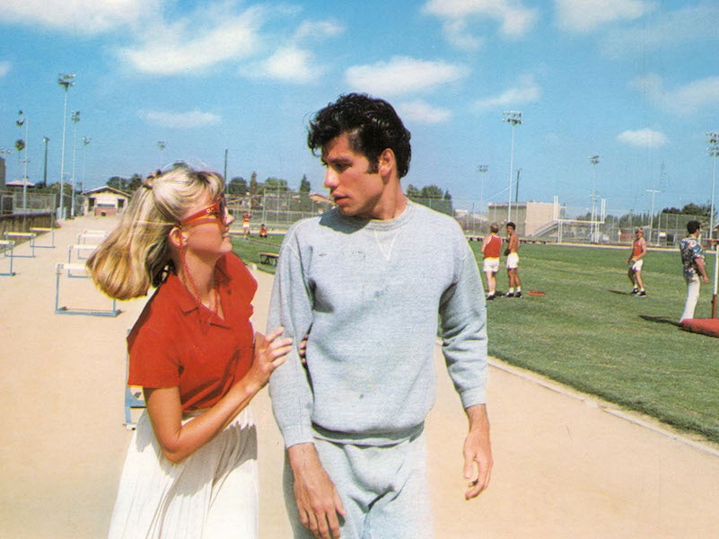 John Travolta in Grease wearing the classic two-piece athletic suit.