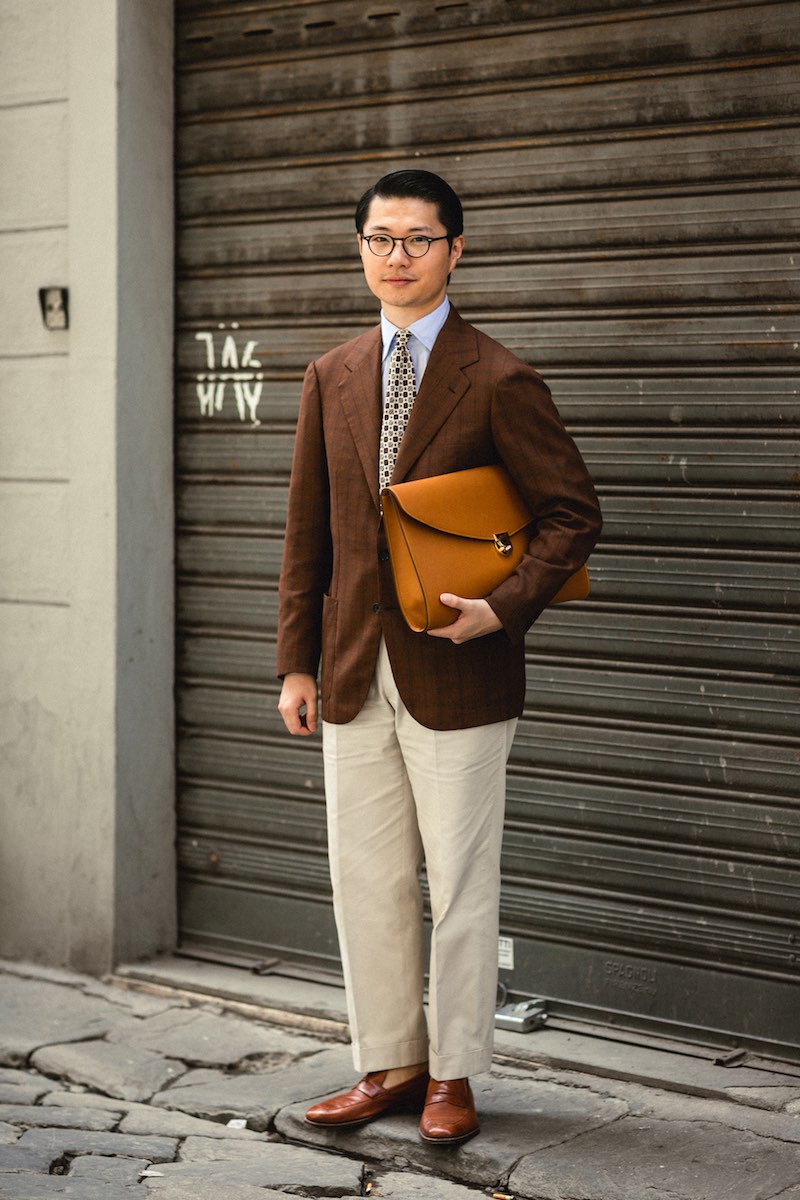 Zing Chen uses the application of a geometric printed tie to bring together his brown jacket and cream trousers.