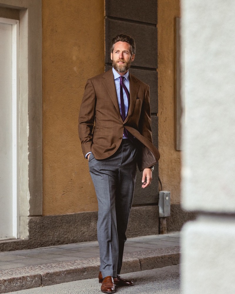 Patrik Löf, co-founder of Skoaktiebolaget, wears a subtle brown windowpane jacket with a simple tailored grey trouser.