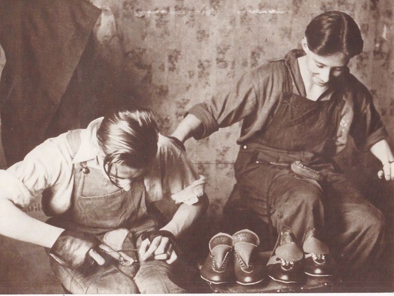 A young Norman Walsh hand welting a pair of leather sports shoes.