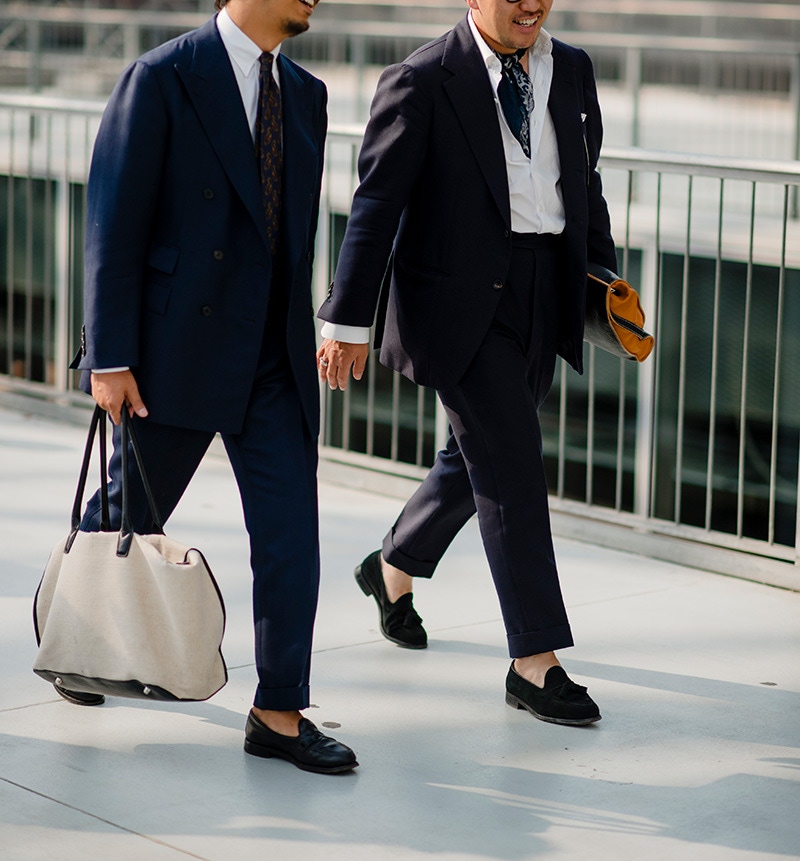 Classic navy suits stride into the modern world with an elegant turn-up and loafers. If you want to stand out in the office, you needn't go crazy or garish.