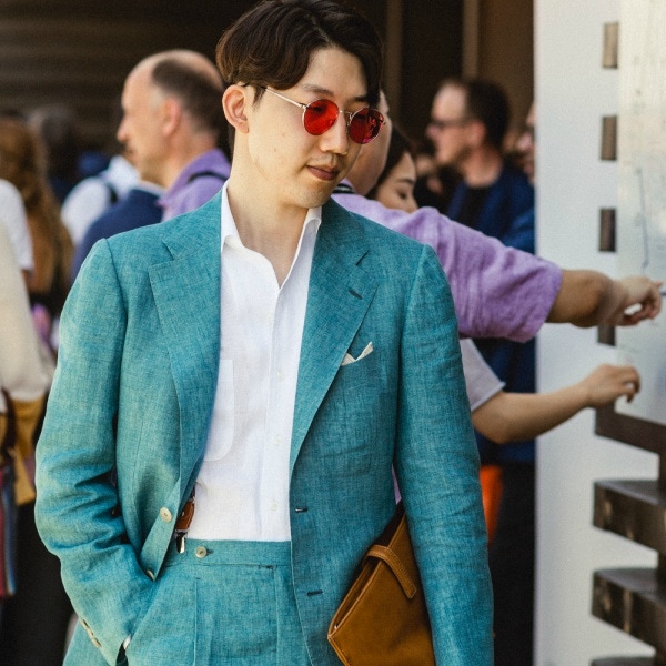 Pink glasses, vibrant blue suiting and tan accessories make for a bold summer statement.