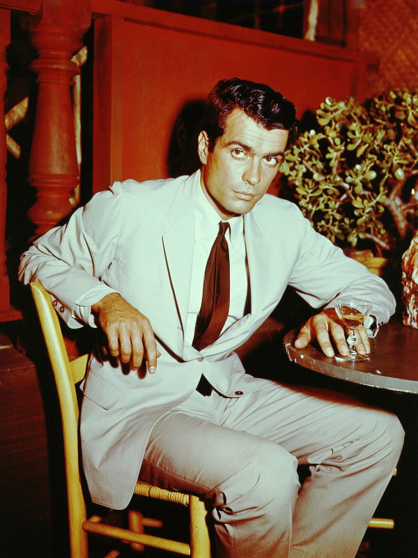 A young McKay in a suit jacket and tie.