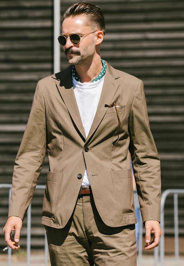 When wearing a bandana with a T-shirt and tailoring, keep it tucked in for a neater finish.