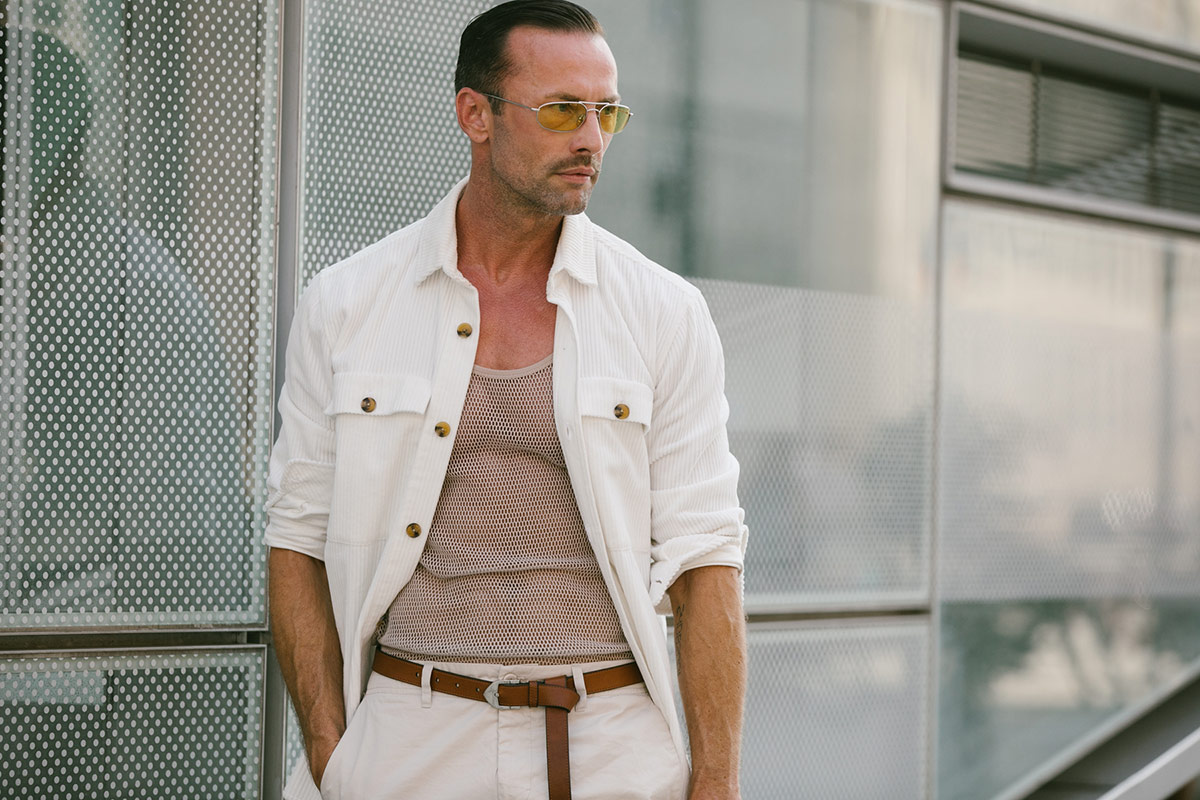 This gentleman shows how effective a crisp white overshirt can be when worn with beige and tan hues.