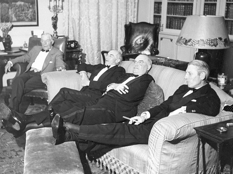 A group of gentlemen put their feet up after dinner following the day's shoot.