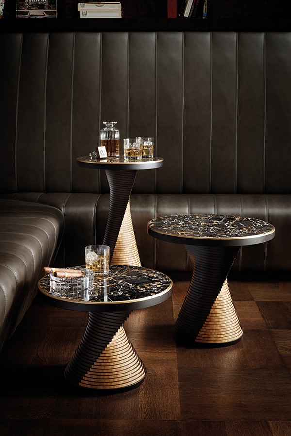 Architectural form meets labour-intensive craft in the Eclipse Side Tables. Contrasting ripple walnut and satinwood finishes on each individual layer guide the eye to examine the twisting movement of the slender base, topped by a crescendo of American walnut, Portoro Gold marble and brushed lacquered brass.