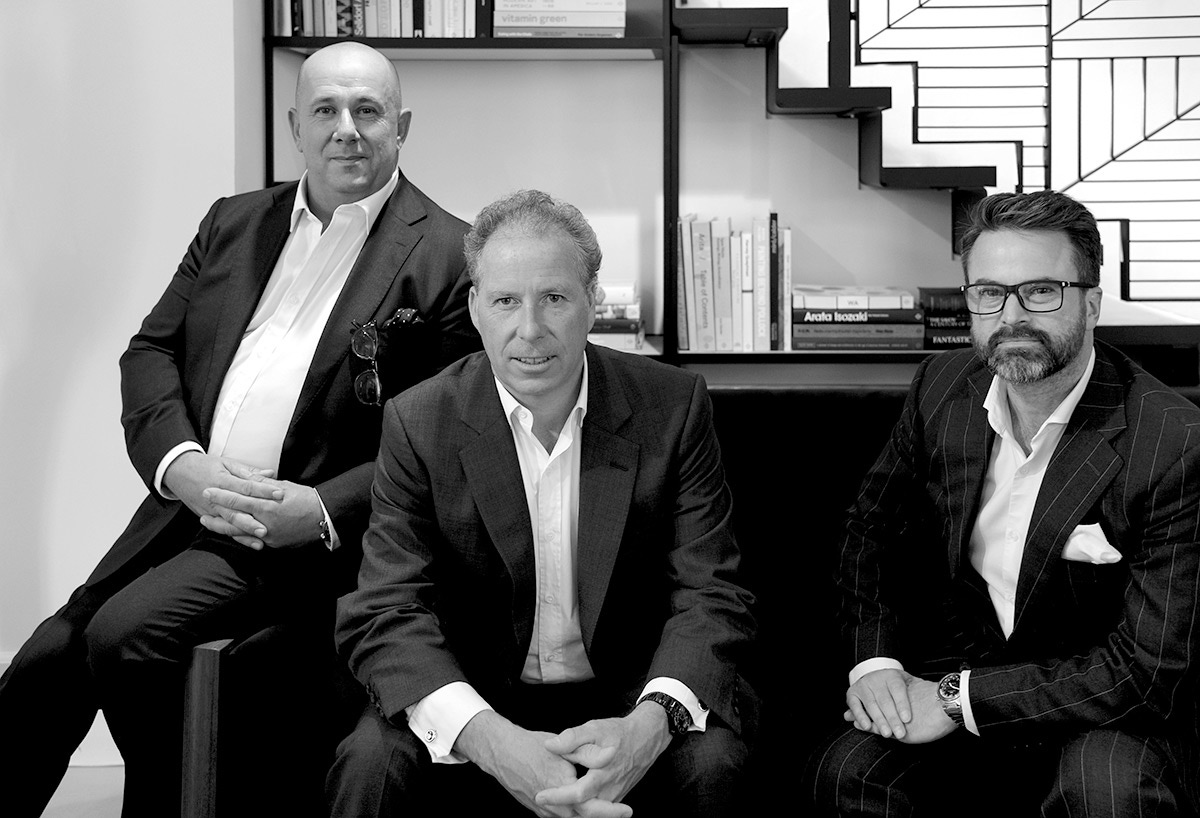 Pictured in the Linley showroom on 60 Pimilco Road, London, David Linley sits flanked by Graham Green and Michael Keech.