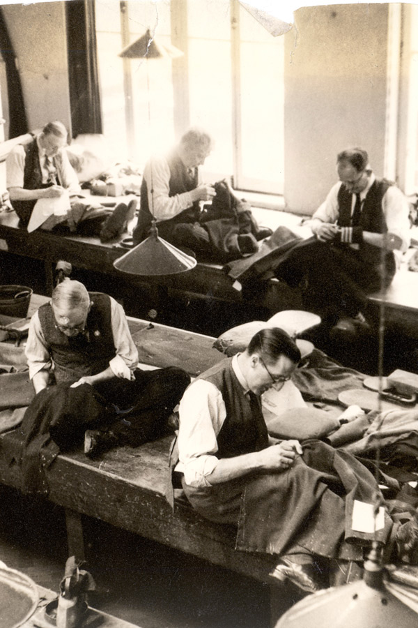 Tailors at work in the Henry Poole cutting room.