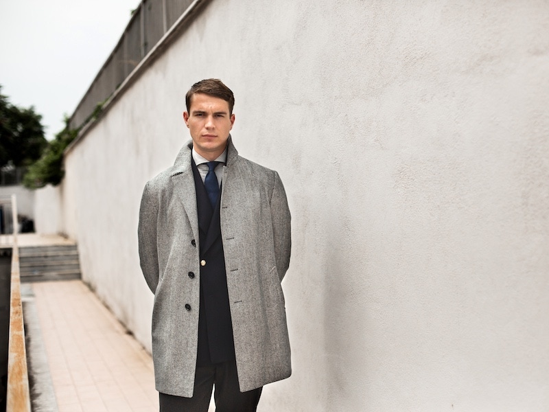 Grey wool herringbone overcoat with a double-breasted navy blazer from De Petrillo. Photography by Shaun Darwood.