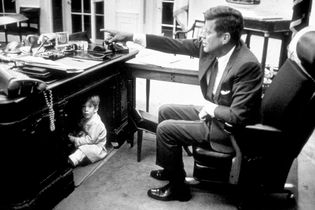 Kennedy and his son John Kennedy Jr. in the Oval Office, 1963 (Photo via Getty)