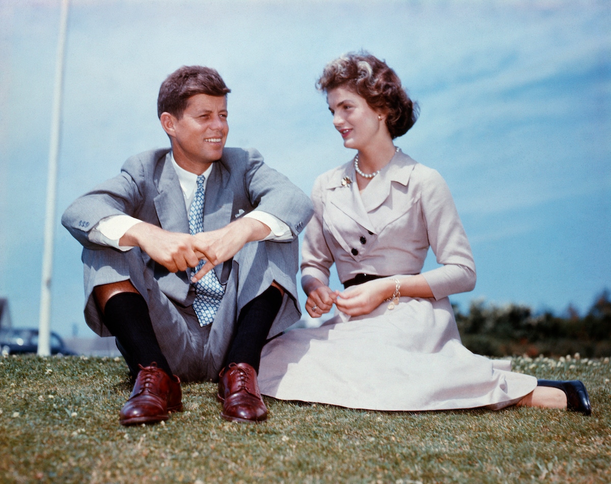 With Jackie at Kennedy’s family home in Hyannis Port, Massachusetts, a few months before their wedding (Photo via Getty)