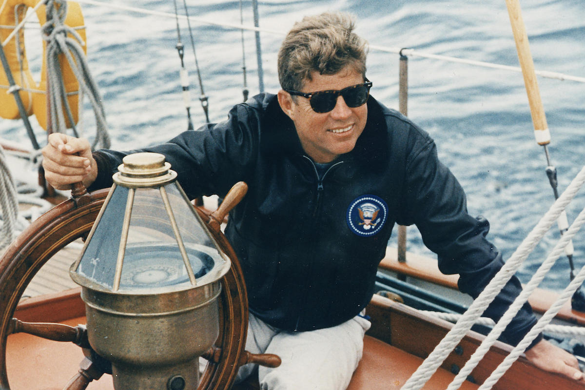 At the wheel of a U.S. Coastguard yacht while on holiday in Maine, 1962