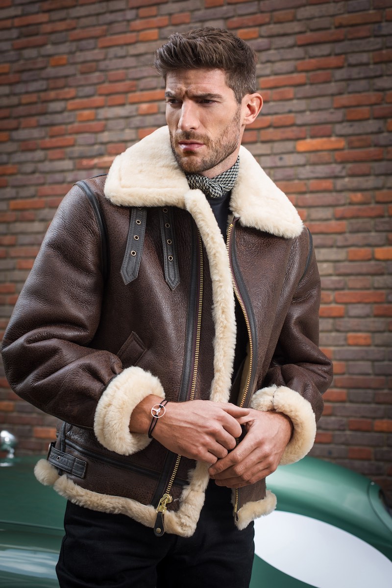 Brown B3 Shearling jacket, Schott; Black cotton short sleeve classic crew neck T-shirt, Sunspel; Black raw Japanese selvedge jean, The Workers Club; 24H Le Mans edition bracelet on black cord, The Mechanist; Brown wool and silk houndstooth neckerchief, Anderson & Sheppard.