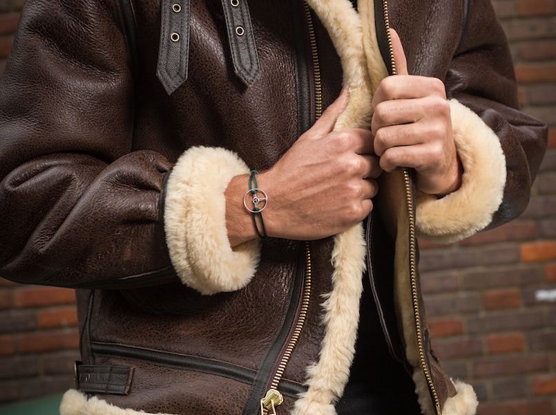 Brown B3 Shearling jacket, Schott; Black cotton short sleeve classic crew neck T-shirt, Sunspel; Black raw Japanese selvedge jean, The Workers Club; 24H Le Mans edition bracelet on black cord, The Mechanist; Brown wool and silk houndstooth neckerchief, Anderson & Sheppard.