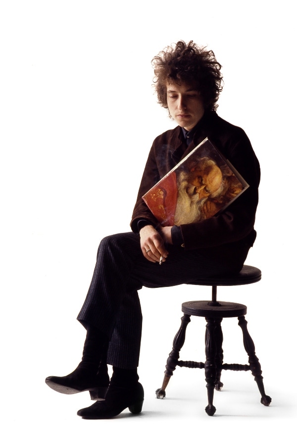 Dylan is pictured smoking a cigarette and holding a prop in Schatzberg's photography studio in the mid-1960s. © Jerry Schatzberg. Courtesy of ACC Art Books.