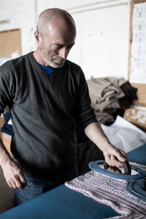 An artisan pressing a garment.