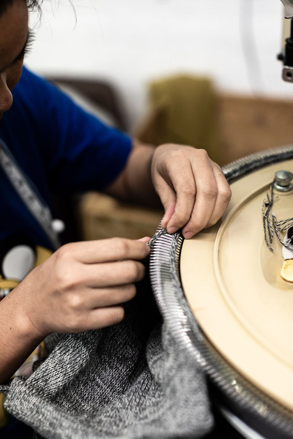 One of Inis Meáin's workers using a knitting machine to create one of the brand's pieces.