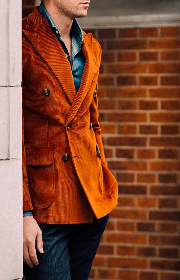 Doppiaa's blood orange corduroy blazer is a striking option to pair with contrasting hues.