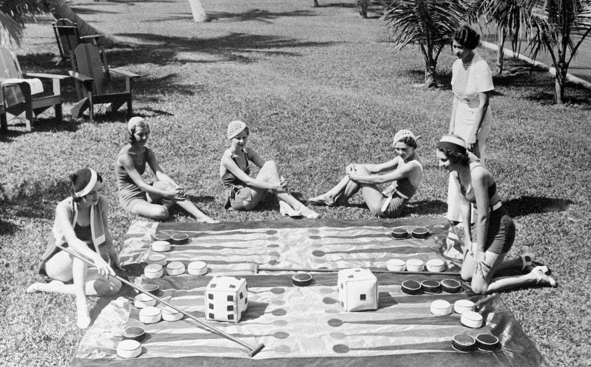 Young bathers playing giant backgammon, a new fashionable game on the beaches of Miami, Florida, United States on April 20, 1932. (Photo by Keystone-FranceGamma-Rapho via Getty Images)