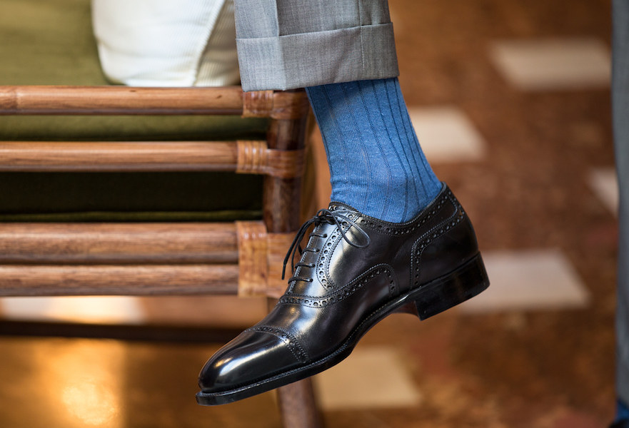 A slick pair of Oxfords worn with a brightly coloured sock makes for an arresting business-appropriate look.