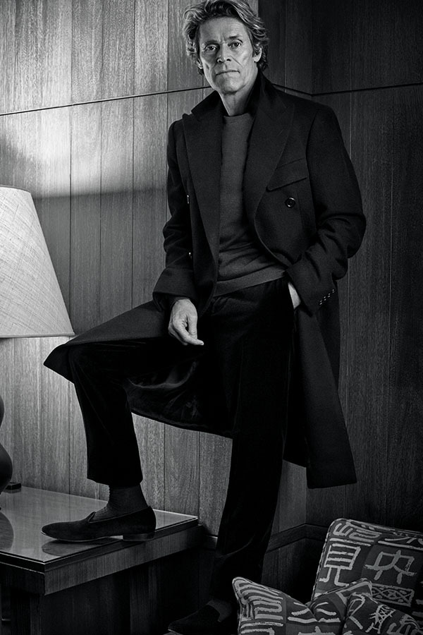 Black wool double-breasted coat and black wool trousers, both Ralph Lauren Purple Label; navy wool jumper, Gieves & Hawkes; black wool socks, Pantherella at The Rake; black velvet slippers, Dolce & Gabbana.