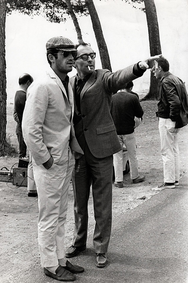 Belmondo off camera, taking instructions from French cinema's greatest director, Jean Luc Godard.