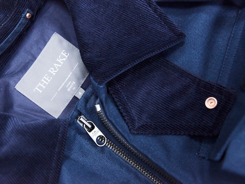 A dual-branded logo alongside the complementing tones of navy cotton canvas and needle corduroy.